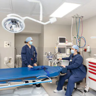 Two care team members preparing an operating room at the Philadelphia surgery center